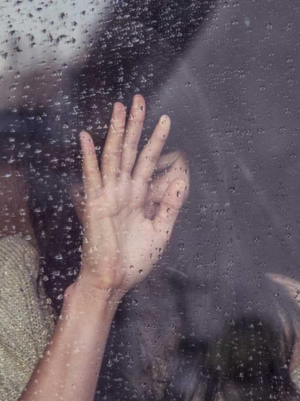 A professional software developer working on a laptop with code on the screen.